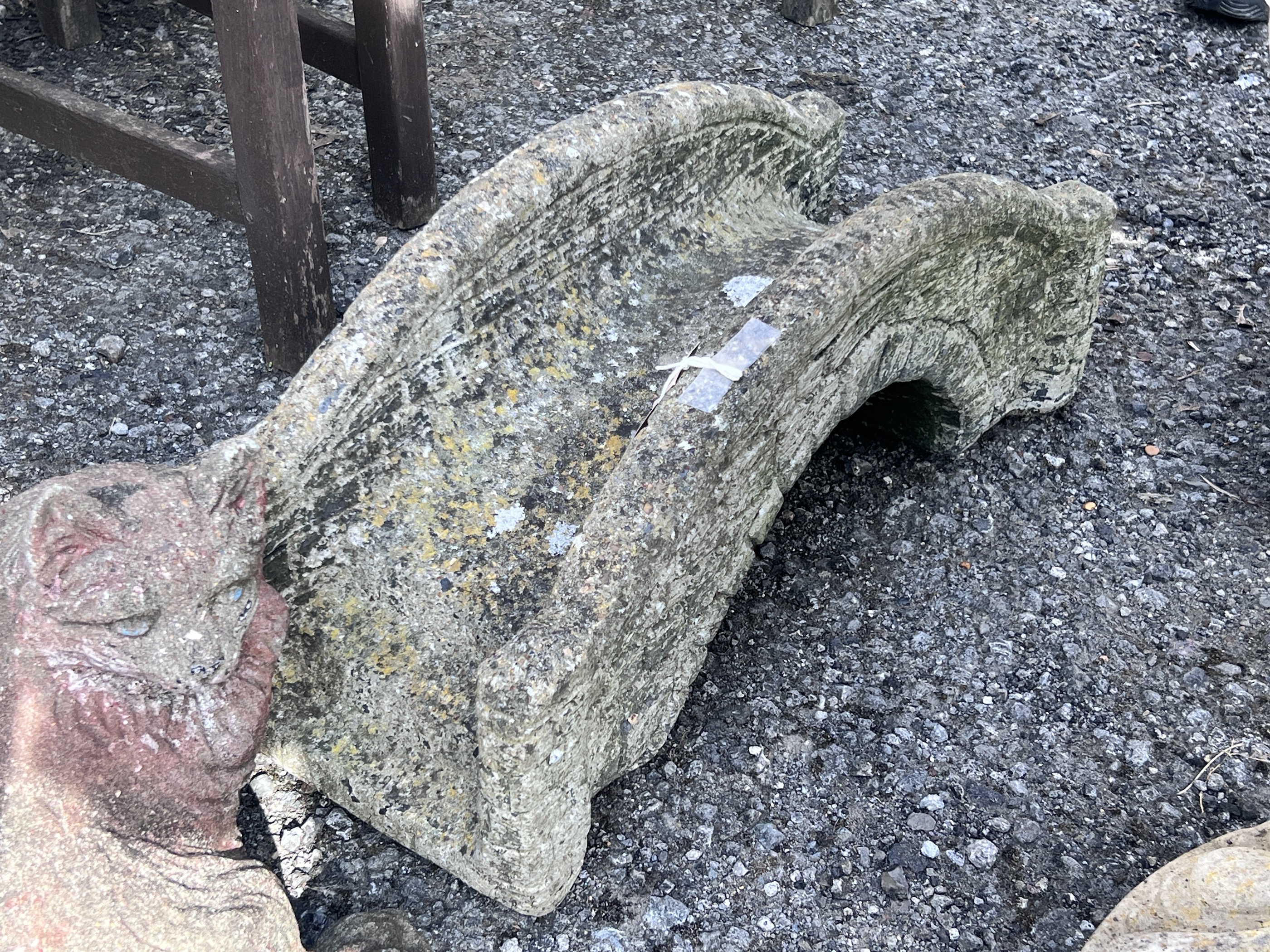 A reconstituted stone ornamental bridge garden ornament, length 59cm, height 25cm, together with a seated cat ornament